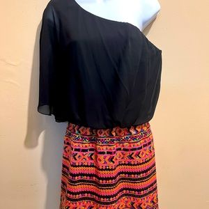 One-shoulder, black upper bodice, bright sequin lower bodice, mid-thigh, sassy